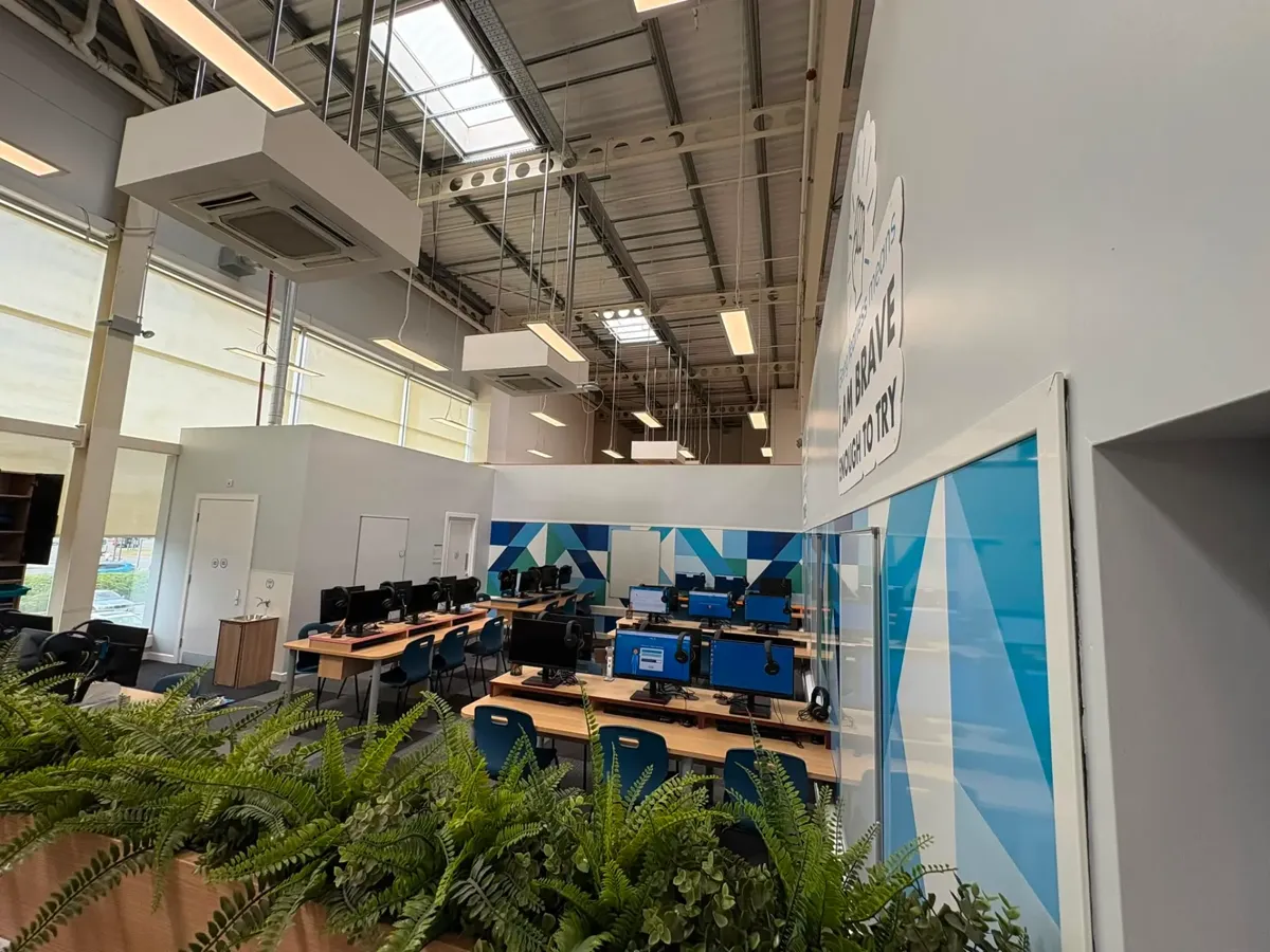 Modern commercial computer lab fit-out with suspended services, acoustic baffles and biophilic planting